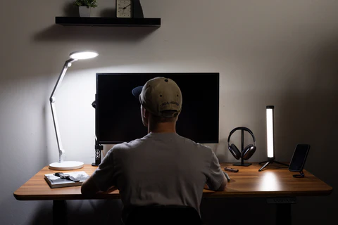 Soft evening light over a desk with a closed laptop and a journal